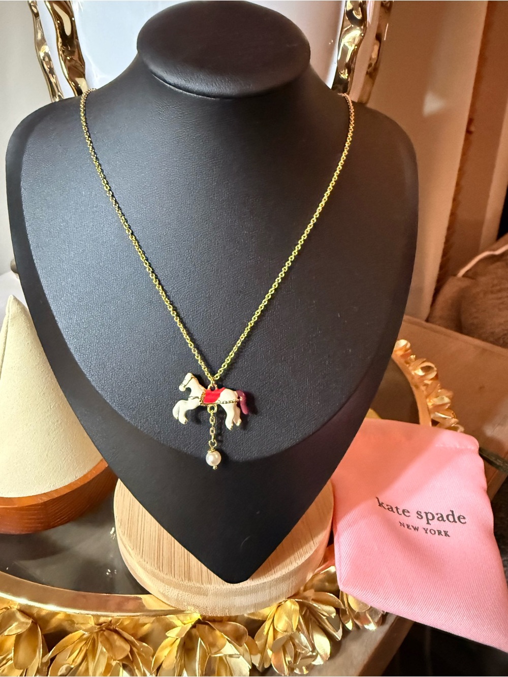 kate spade gold-tone carousel horse pendant necklace with red and pink accents